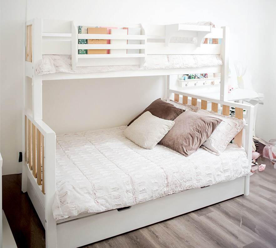 White wooden bunk bed with cozy pillows and blankets, perfect for a modern children's room.