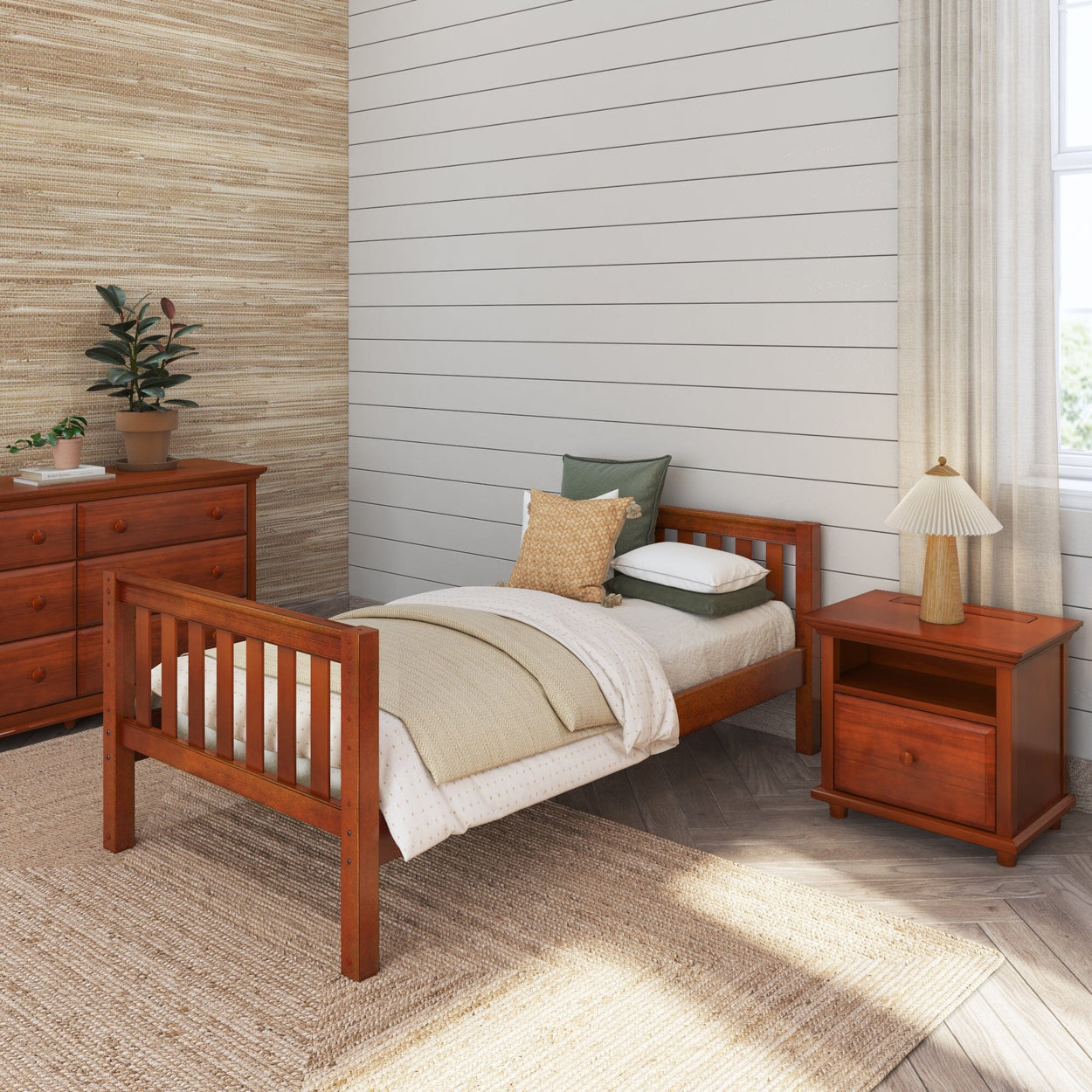 Cozy bedroom with wooden single bed, nightstand, dresser, and decorative plant.