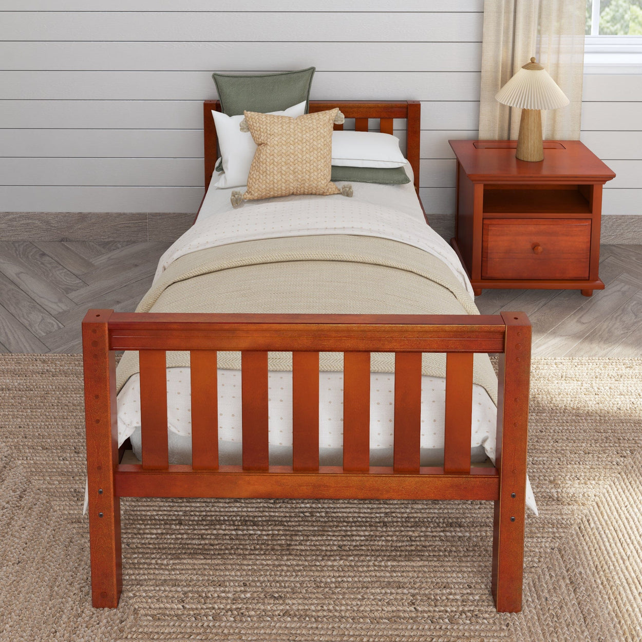 Wooden twin bed with beige bedding and a matching nightstand in a cozy bedroom setting.