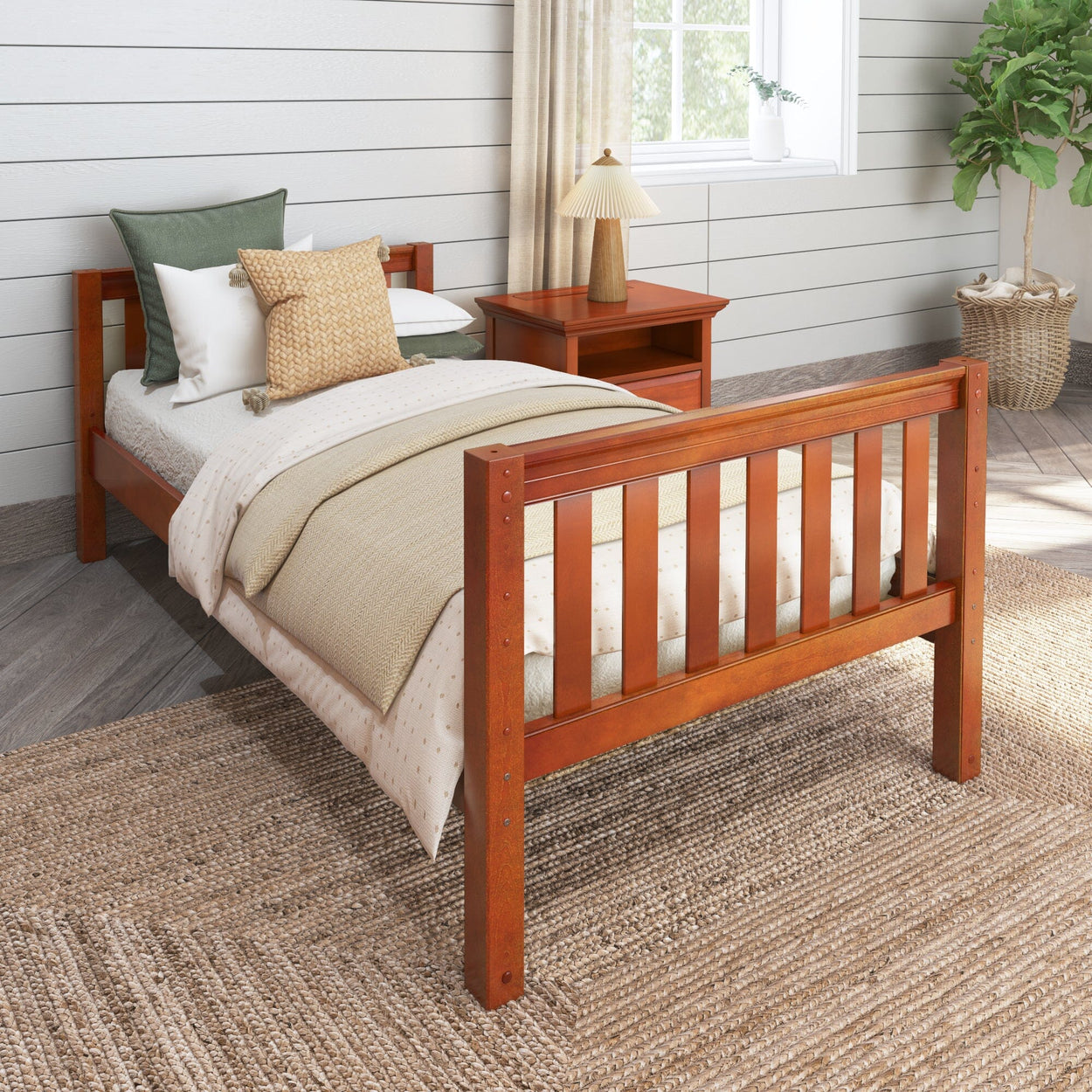 Wooden twin bed with green and beige bedding in a cozy bedroom setting with natural light.