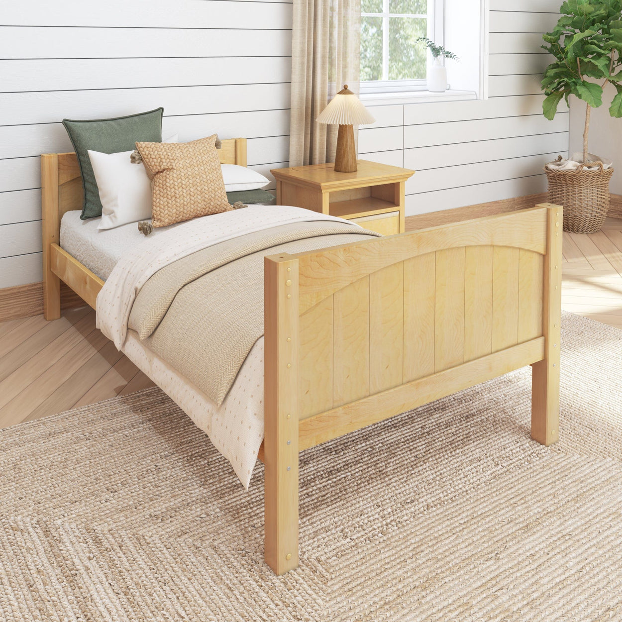 Single wooden bed with decorative pillows in a cozy bedroom setting featuring a side table and a potted plant.