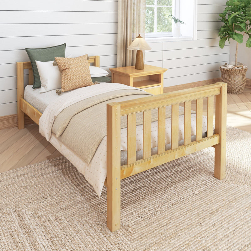 Cozy neutral farmhouse bedroom with light wooden bed frame, beige knit and green throw pillows, wooden nightstand with lamp, shiplap wall and potted fiddle leaf fig