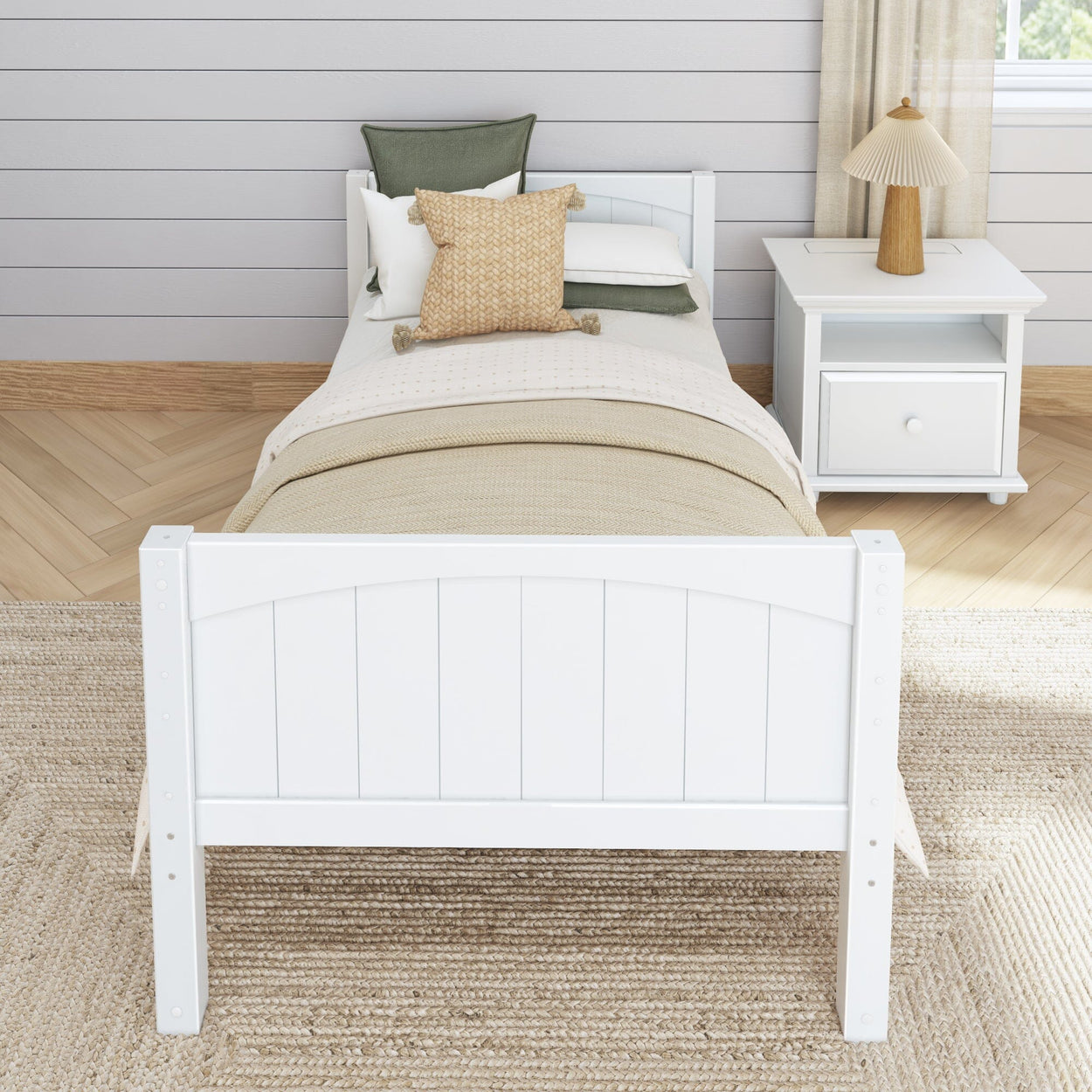 White wooden bed with beige bedding and decorative pillows in a modern neutral bedroom setting.