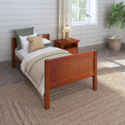 Rustic wooden twin bed with cozy bedding in a bright modern bedroom featuring a wicker rug, stylish nightstand, and lush potted plant by the window.