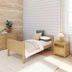 Cozy minimalist bedroom with wooden single bed, nightstand, and dresser, featuring natural decor and soft lighting.