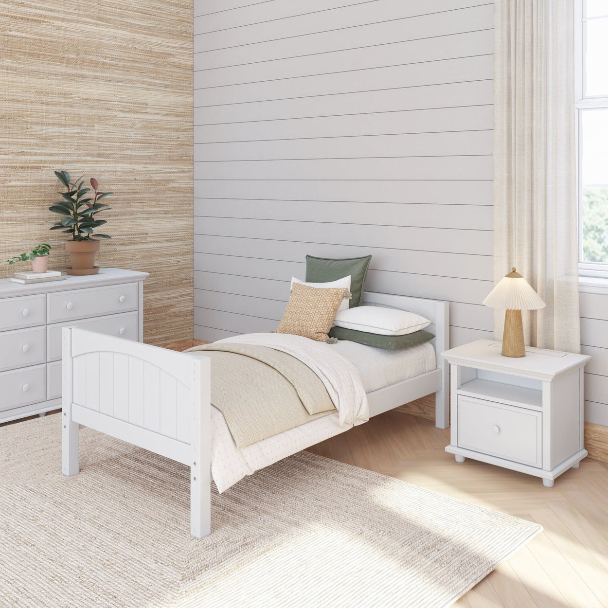 Modern minimalist bedroom with white bed frame, cozy beige bedding, wooden nightstand with lamp, and dresser against textured wall.