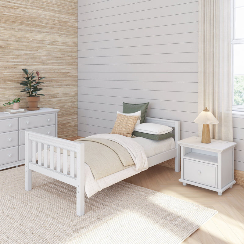 Cozy neutral bedroom with white wooden bed, shiplap accent wall, grasscloth wallpaper, natural fiber rug, nightstand lamp and potted plants