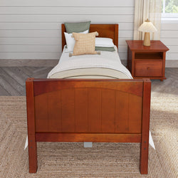 Wooden twin bed with neutral bedding and a nightstand in a cozy, modern bedroom.