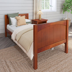 Wooden twin bed with cozy bedding in a modern bedroom setting.