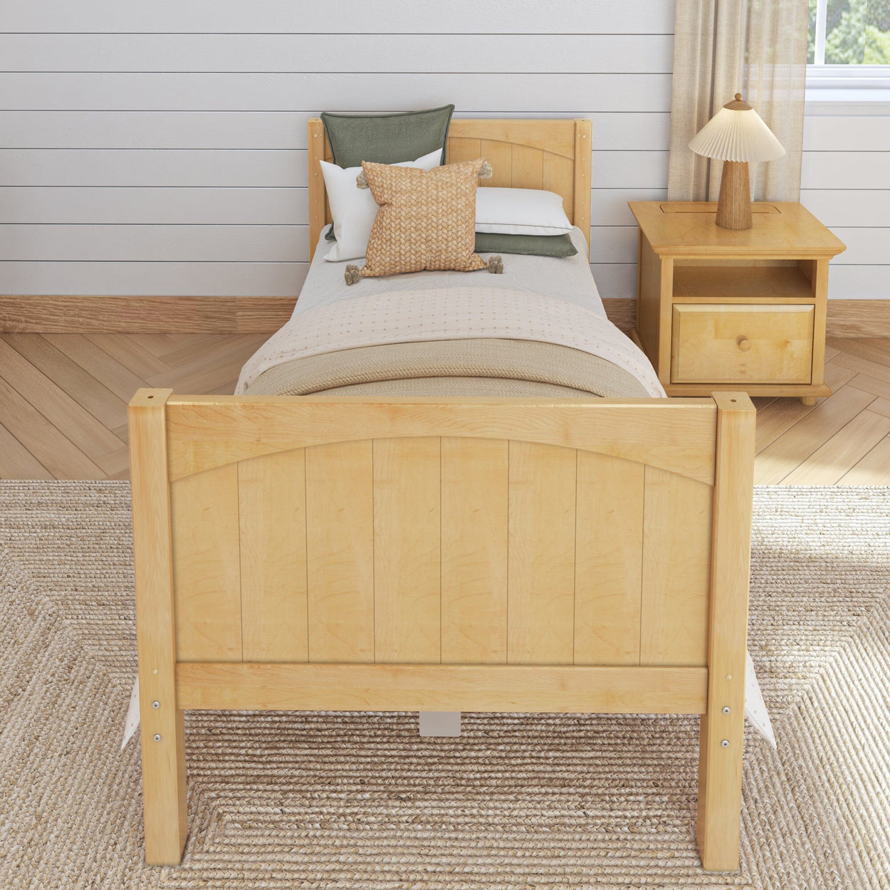 Wooden single bed with cozy bedding and a bedside table in a stylish bedroom setting.
