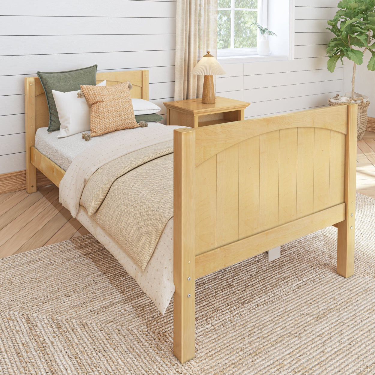 Light wood bed frame in cozy bedroom with textured bedding, side table, and natural decor.