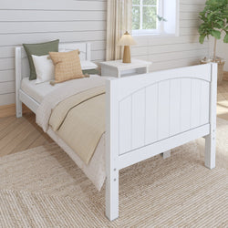 Single wooden bed with white frame and earth-toned bedding in a cozy modern bedroom.