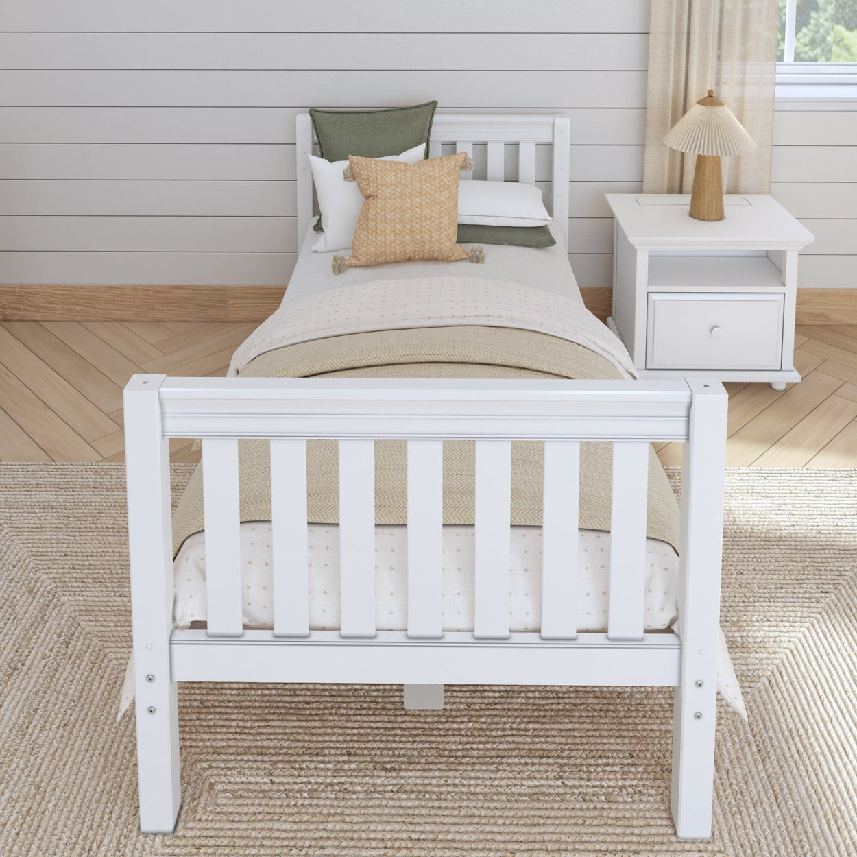Single white wooden bed with bedding and side table in a cozy bedroom setting.