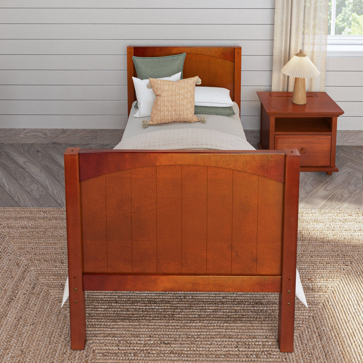 Wooden single bed frame with white and green bedding in a cozy bedroom setting, featuring a nightstand and decorative lamp.