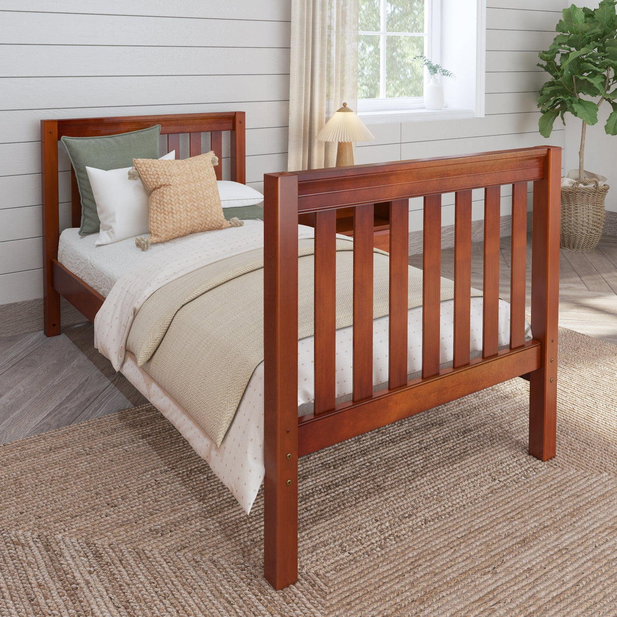 Wooden twin bed with cozy bedding and plant decor in a bright bedroom.