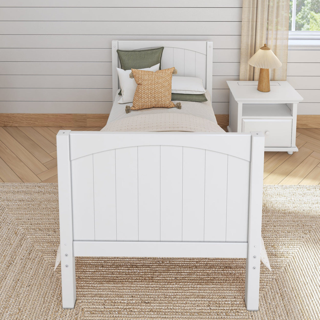 Wooden twin bed with white frame and cozy pillows in a modern bedroom setting.