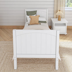Wooden twin bed with white frame and cozy pillows in a modern bedroom setting.