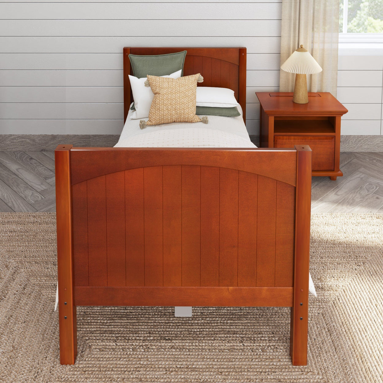 Wooden twin bed with matching nightstand and cozy décor in a modern bedroom setting.