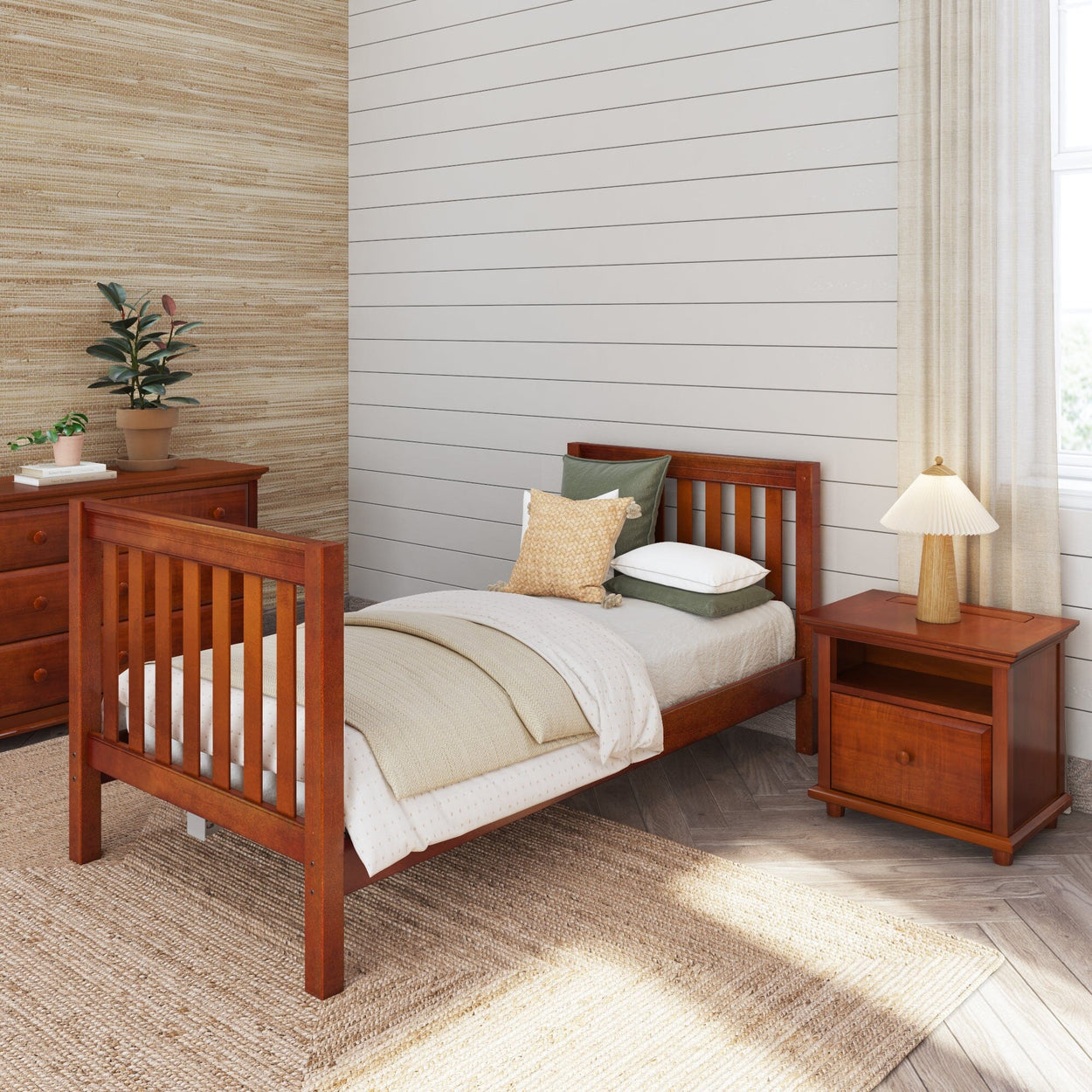 Wooden twin bed in a modern bedroom with nightstand and dresser, featuring cozy bedding and natural decor.