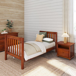Wooden twin bed in a modern bedroom with nightstand and dresser, featuring cozy bedding and natural decor.