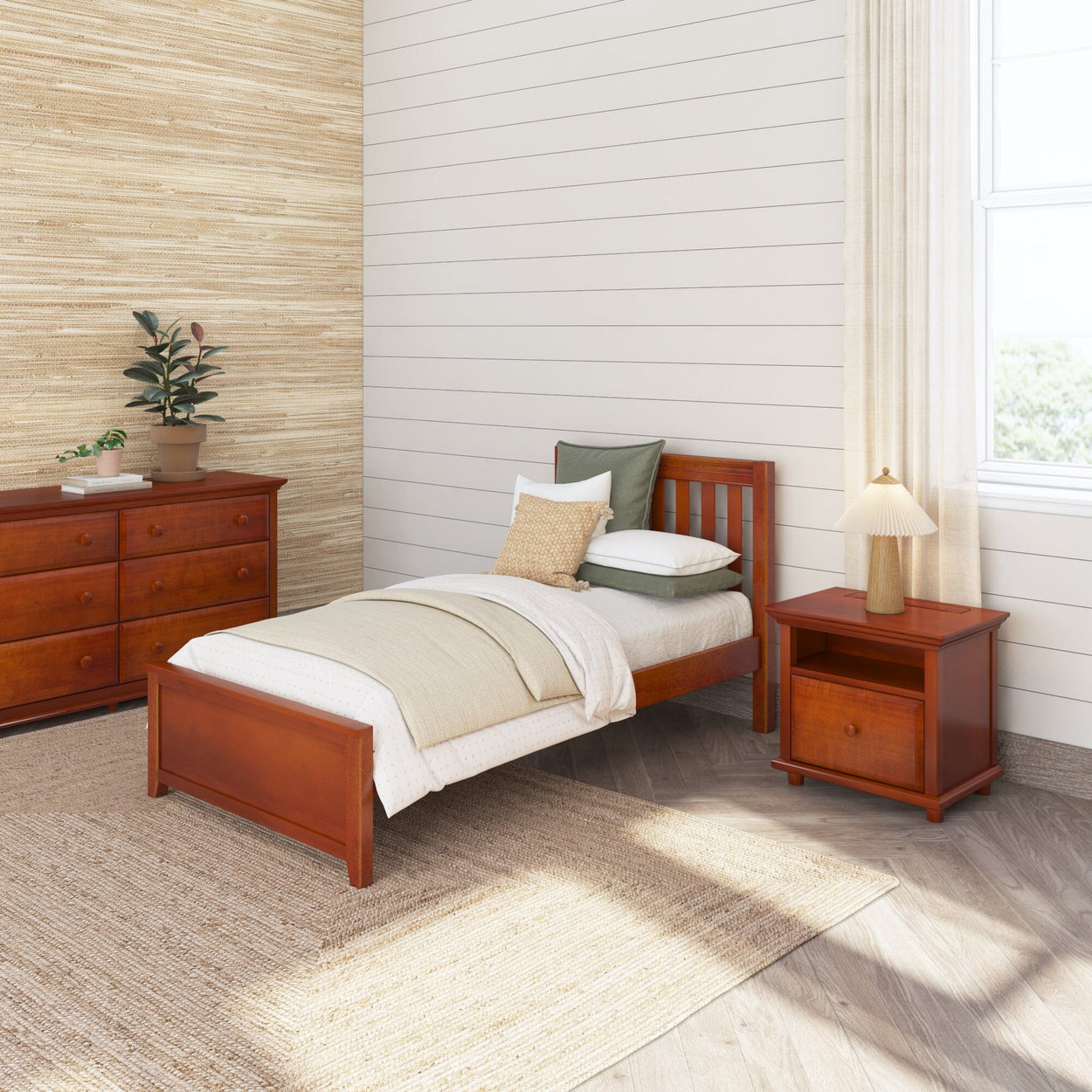 Elegant bedroom with wooden twin bed, matching nightstand, and dresser against light wood-paneled walls, featuring neutral bedding and a potted plant for a cozy, minimalist design.