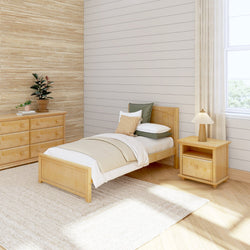 Modern minimalist bedroom with natural wooden furniture, single bed, and neutral decor.