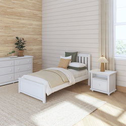Cozy minimalist bedroom with white furniture, single bed, nightstand, and dresser, featuring neutral tones and natural light.