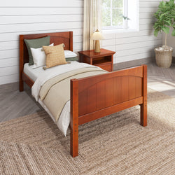 Wooden twin bed with neutral bedding in modern bedroom with side table and lamp.