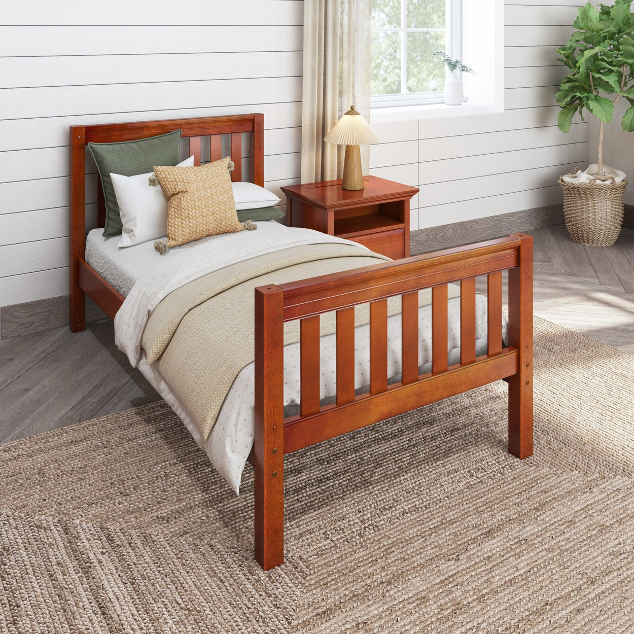 Wooden twin bed with cozy bedding and bedside table in a bright, rustic bedroom.