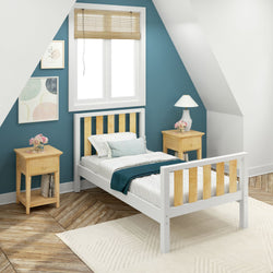 Cozy attic bedroom with a blue accent wall, wooden bed, white bedding, and two wooden nightstands with lamps and flowers.