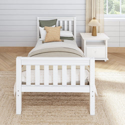 White wooden bed with decorative pillows and a nightstand in a cozy, modern bedroom setting.