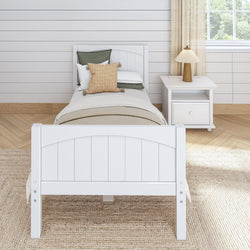 White wooden bed frame with decorative pillows and nightstand in a cozy bedroom.