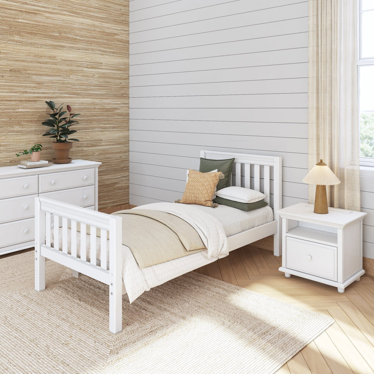 Cozy farmhouse-style bedroom with white bed, nightstand, and dresser, featuring neutral decor and natural light.