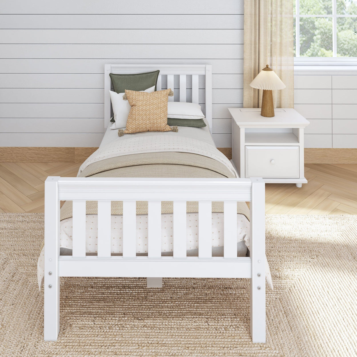 White wooden twin bed with neutral bedding and pillows in a modern minimalist bedroom.