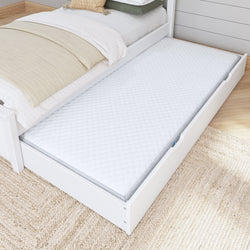 Trundle bed with pull-out mattress on wooden floor in cozy bedroom setting.