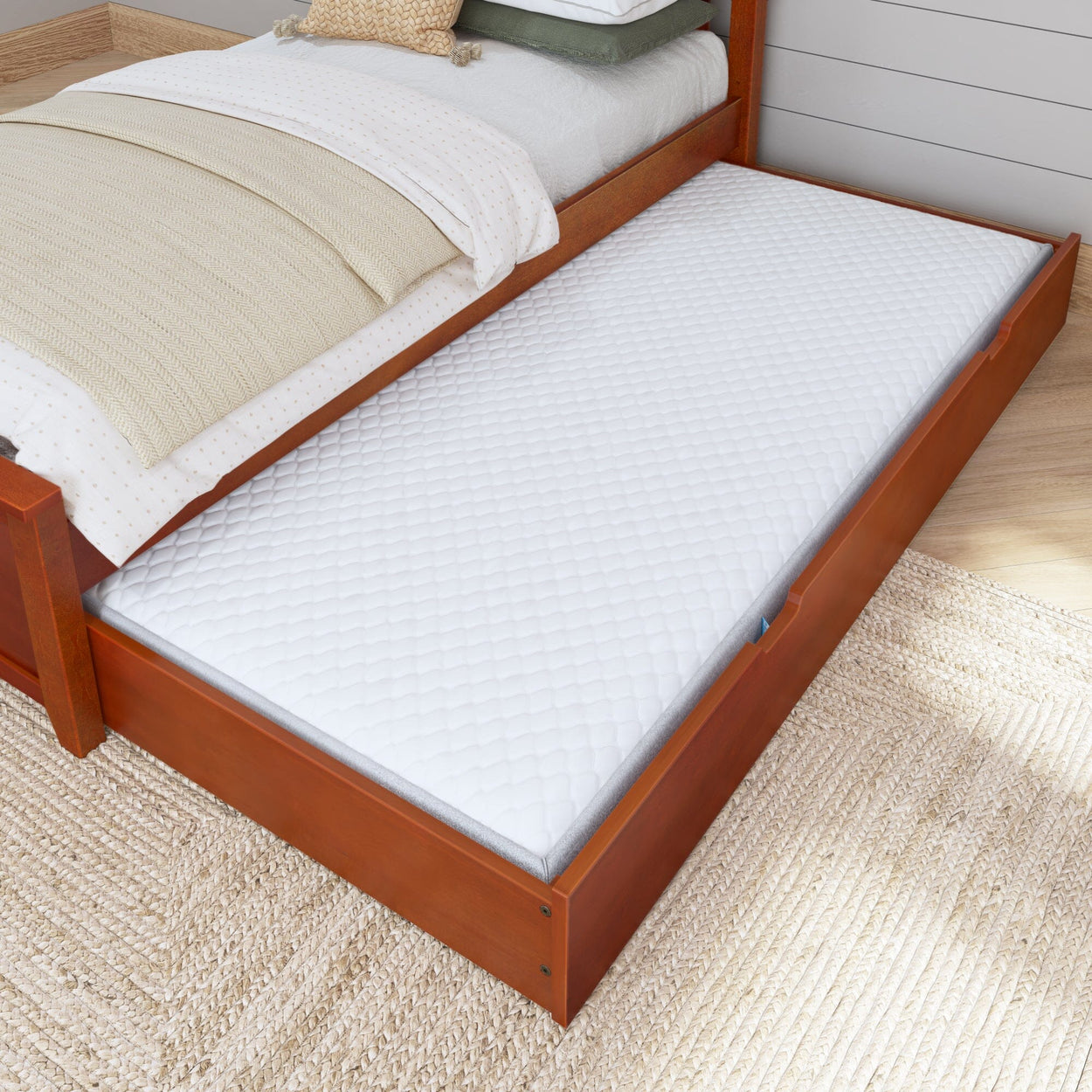 Stylish wooden bed frame with pull-out trundle bed featuring a comfortable white mattress, perfect for space-saving bedroom solutions.