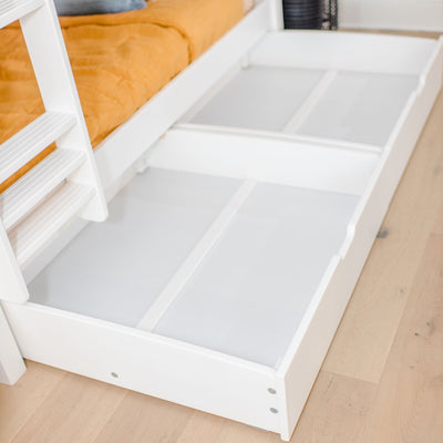 Under-bed storage drawer with white finish in modern bedroom.