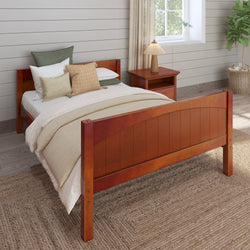 Wooden bed frame with beige bedding and decorative pillows in a cozy bedroom setting.