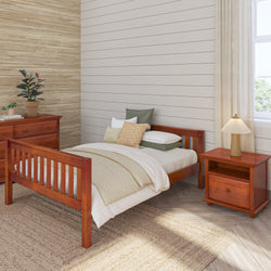 Wooden bedroom furniture set with cozy bed, nightstand, and dresser in a well-lit room, featuring earthy tones and natural decor elements.