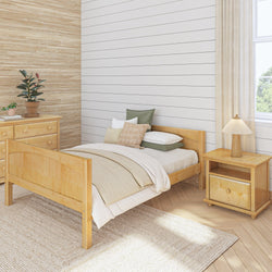 Cozy bedroom with wooden bed, nightstand, and natural decor elements.