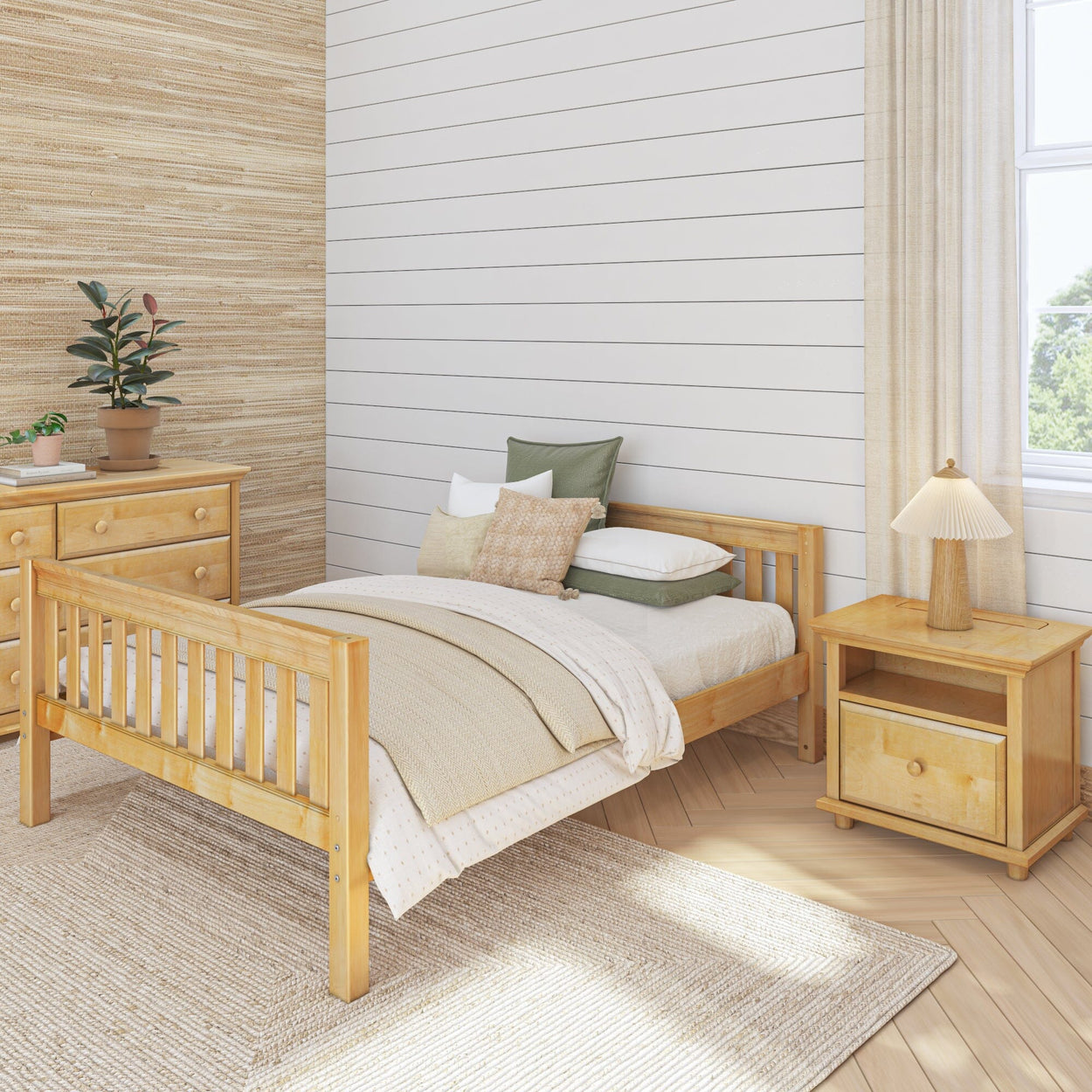 Wooden bedroom furniture set featuring a single bed, nightstand, and dresser with neutral bedding in a cozy, light-filled room.