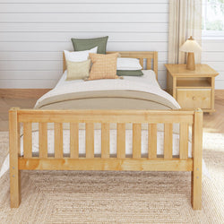 Wooden bed frame with cozy bedding in stylish bedroom setting.