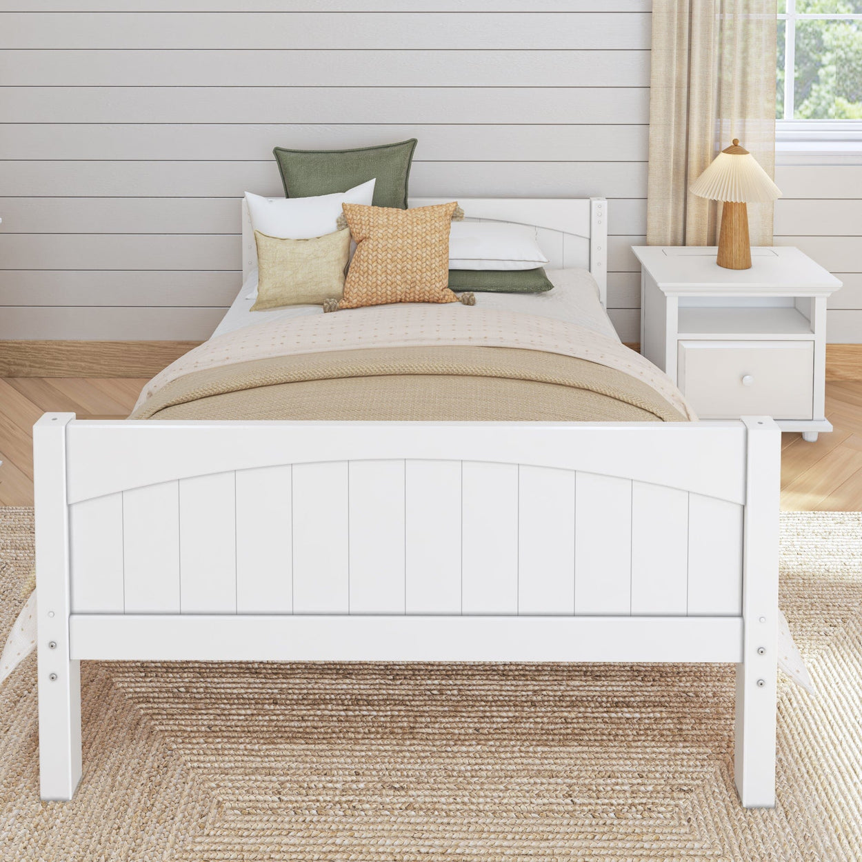 White wooden bed frame with cozy pillows and beige blanket in a modern bedroom setting, featuring a nightstand and table lamp.