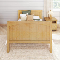 Wooden bed frame with green and beige pillows in a modern cozy bedroom.