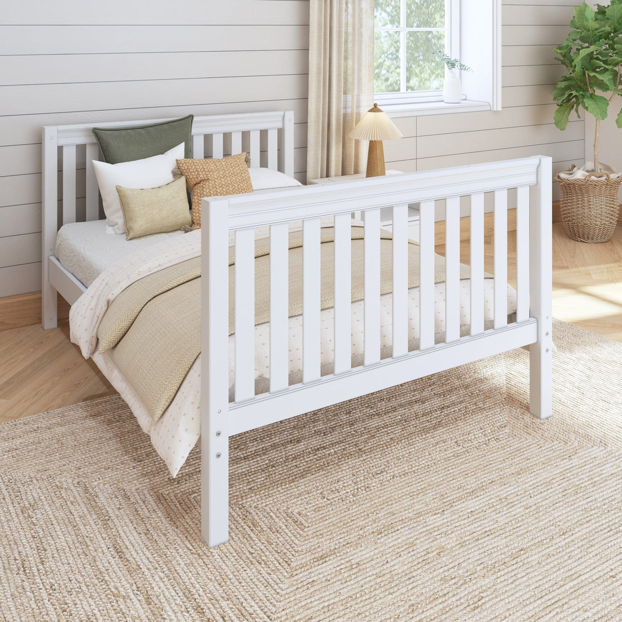White wooden bed frame in cozy bedroom with natural light, soft cushions, and beige bedding.