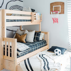 Children's bedroom with wooden bunk bed, basketball hoop wall decor, and soccer ball theme bedding.