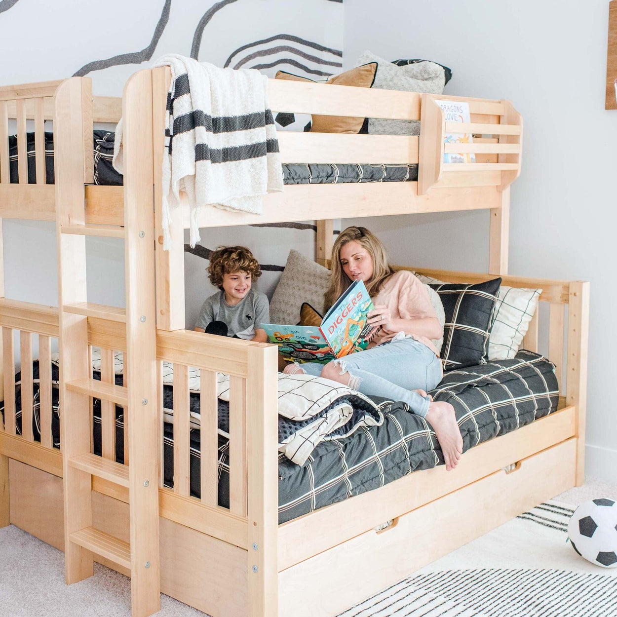 Family enjoying storytime in cozy kids' room with wooden bunk bed.