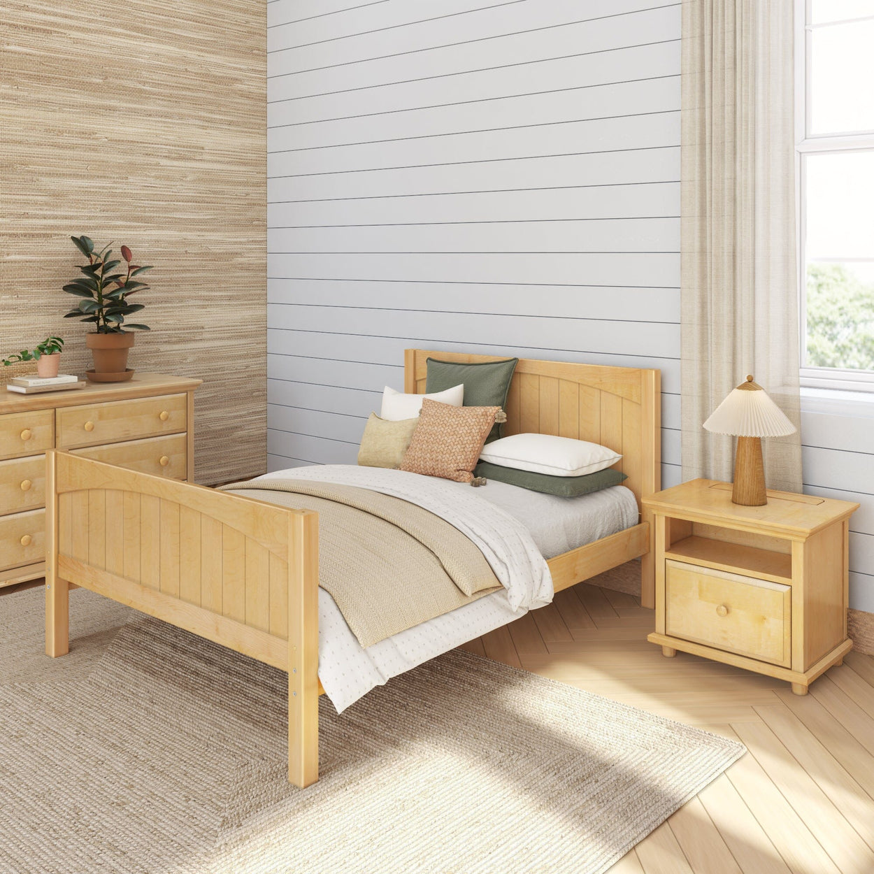Cozy bedroom with wooden bed frame, matching dresser, indoor plant, and soft neutral decor.
