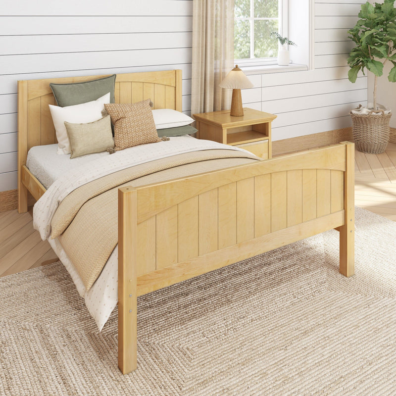 Cozy farmhouse bedroom with light wood bed and headboard, neutral layered bedding and textured pillows, wooden nightstand with lamp, shiplap wall, woven jute rug and fiddle leaf fig plant by a sunlit window