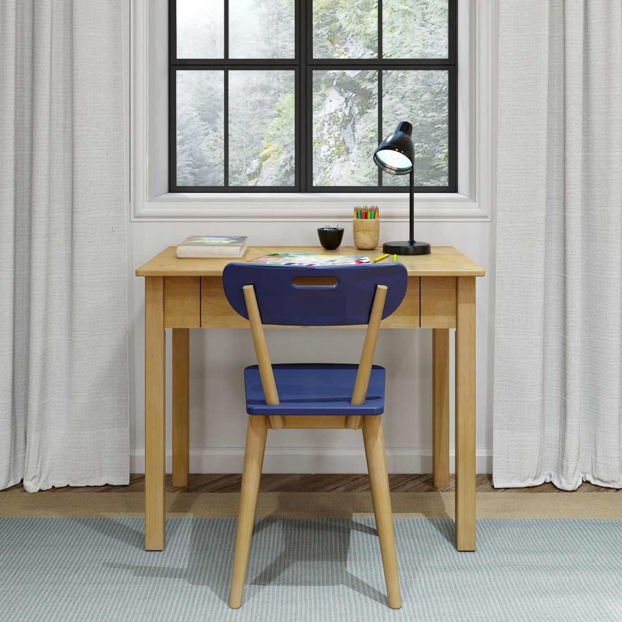 Study desk with blue chair and lamp in front of window, ideal for a home office or student workspace.